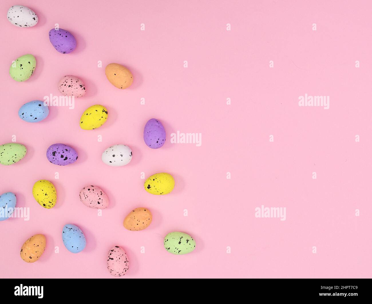 Easter copy space background with colorful eggs on pastel pink theme ...