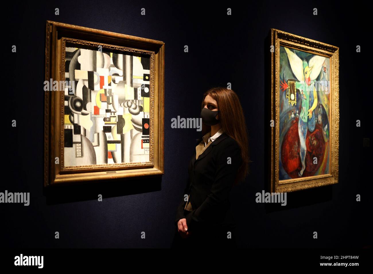 A gallery assistant poses by an artwork titled 'Composition' by Fernand Leger ahead of '20th / 21st Century and Art of the Surreal Evening Sale' auction at Christie's in London, Britain, February 23, 2022. REUTERS/Tom Nicholson Stock Photo