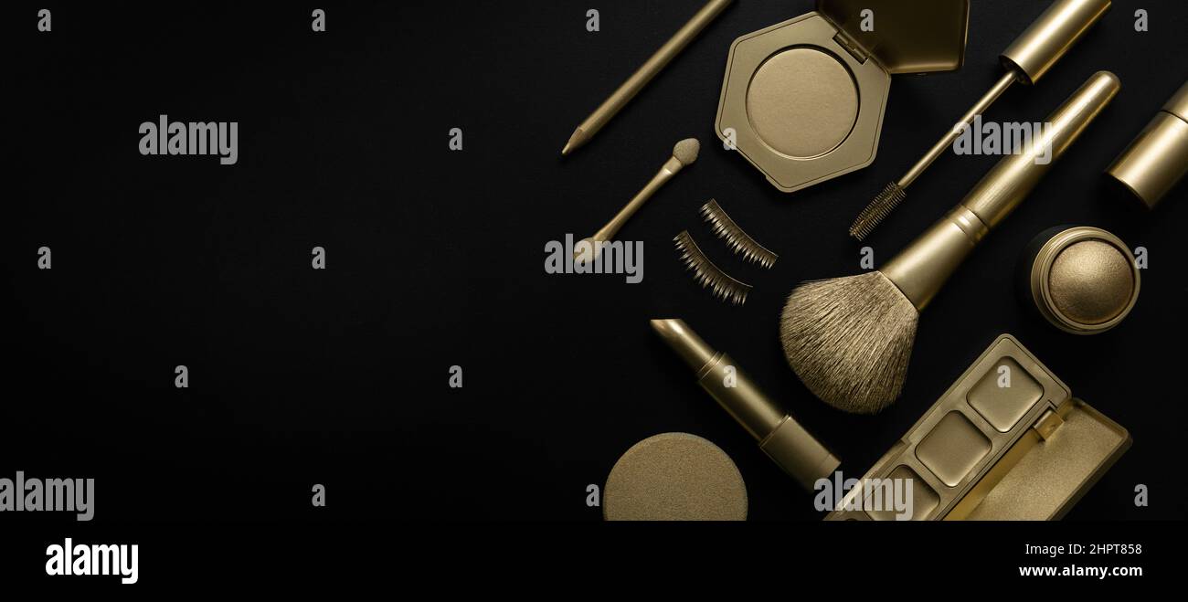 golden colored decorative cosmetics and beauty products on black background. banner copy space Stock Photo