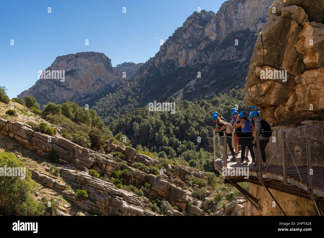 El Chorro, Spain - 22 February, 2022: tourists enjoy hiking the Camino del Rey on a bautiful winter day Stock Photo