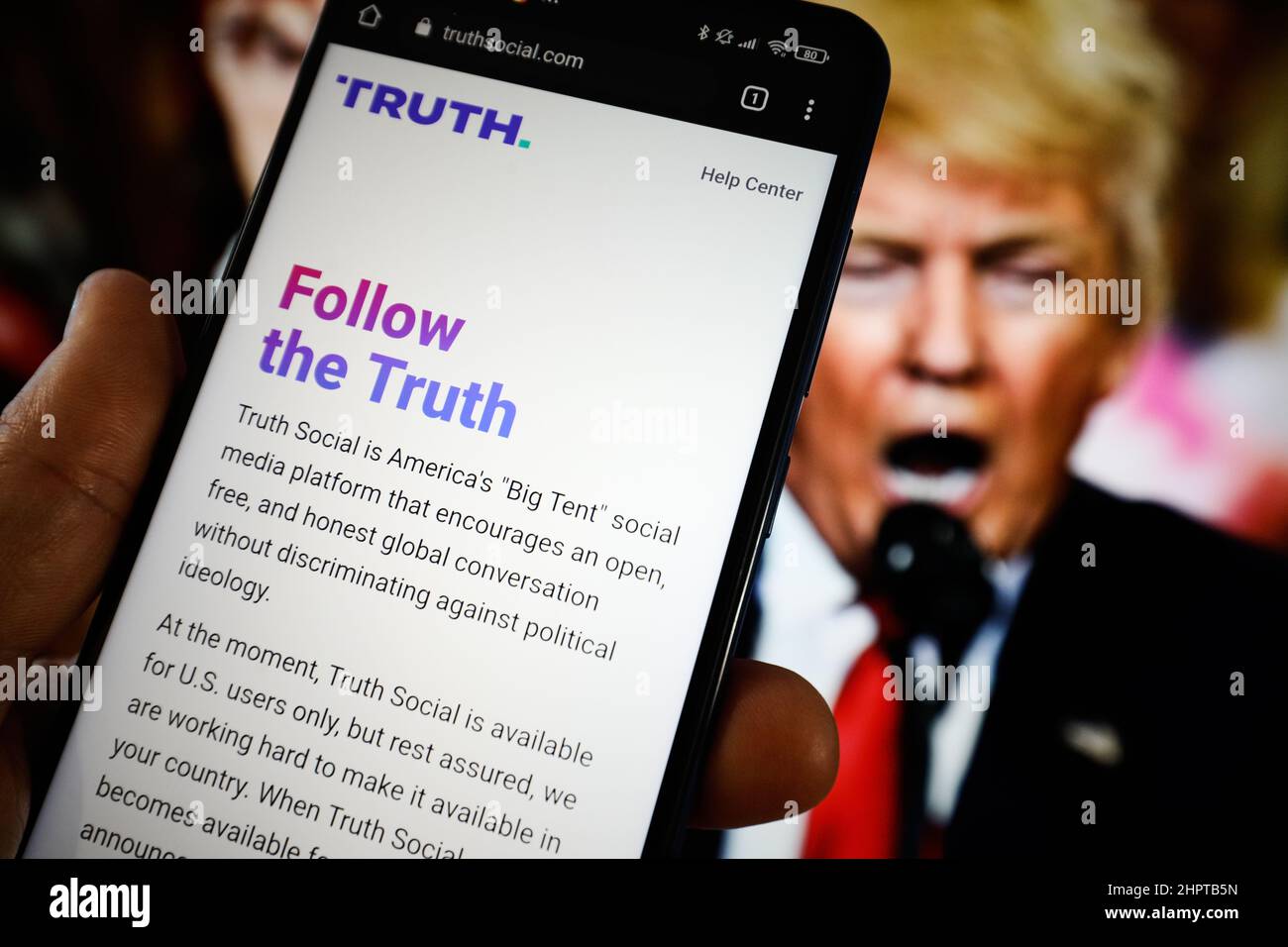 Warsaw, Poland. 23rd Feb, 2022. The TRUTH Social website is seen on a mobile device with an image of former US president Donald Trump in the background in this photo illustration in Warsaw, Poland on 23 February, 2022. TRUTH Social is a newly developed social media platform by the Trump Media and Technology Group (TMTG) modelled after Twitter. The initiative was taken after Trump himself had been banned from Facebook and Twitter in 2021. (Photo by Jaap Arriens/Sipa USA) Credit: Sipa USA/Alamy Live News Stock Photo