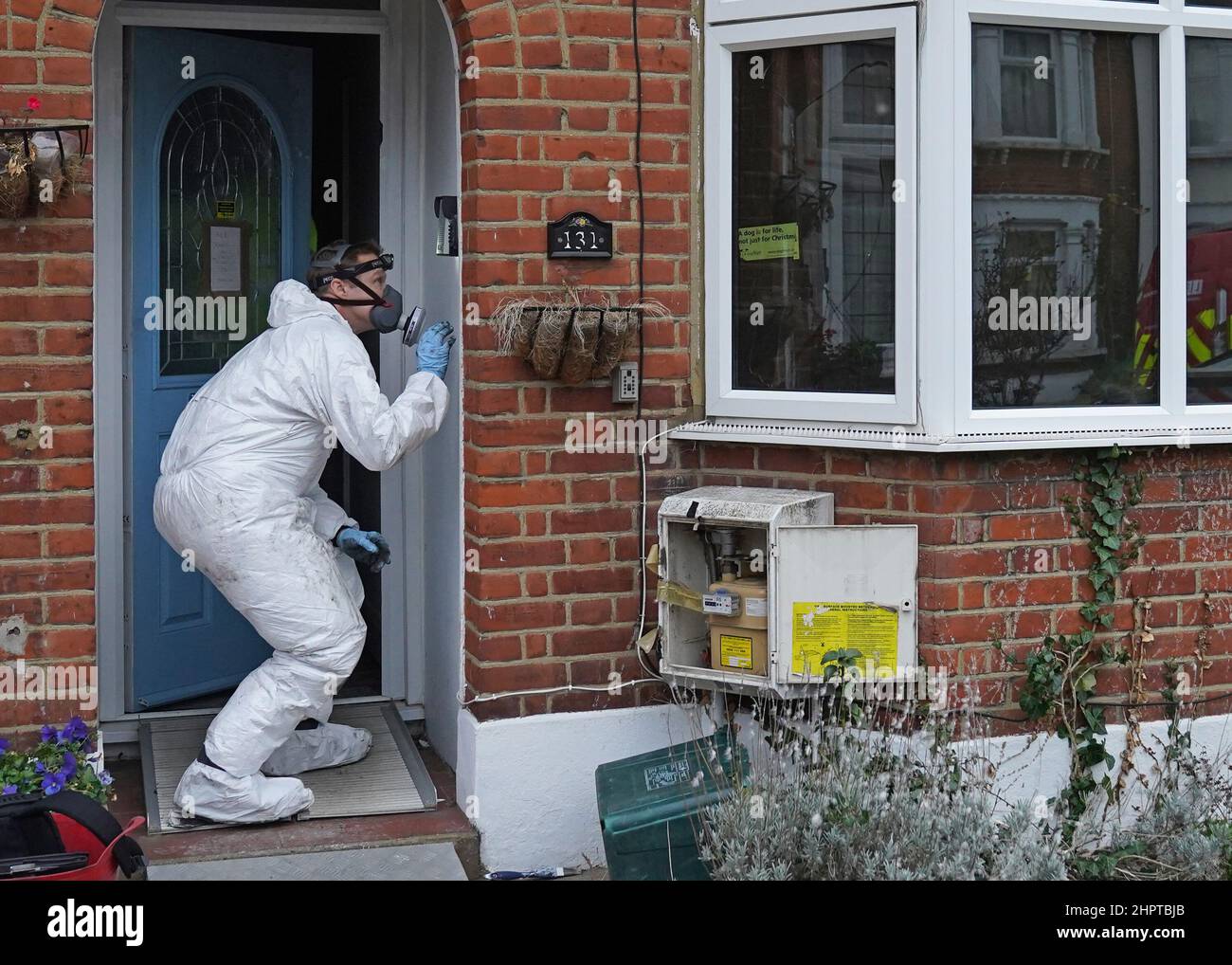 A forensic officer at the scene of a house fire on Windsor Road, Ilford