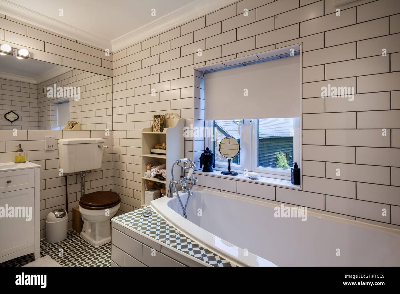 Very traditional appearing modern bathroom with off white fully tiled ...