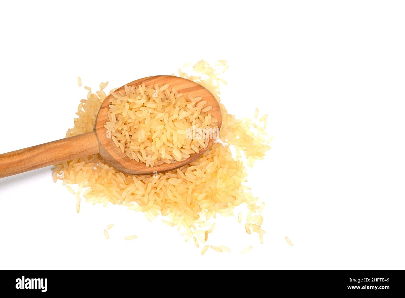 Rice grains and wooden spoon isolated against white background Stock ...