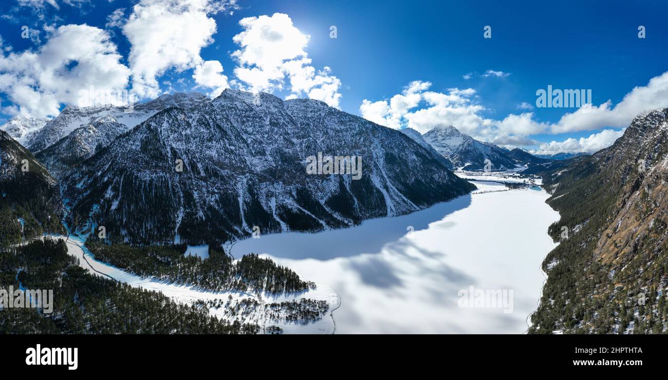 frozen heiterwanger lake in winter surrounded by snowy mountains in austria's alps Stock Photo