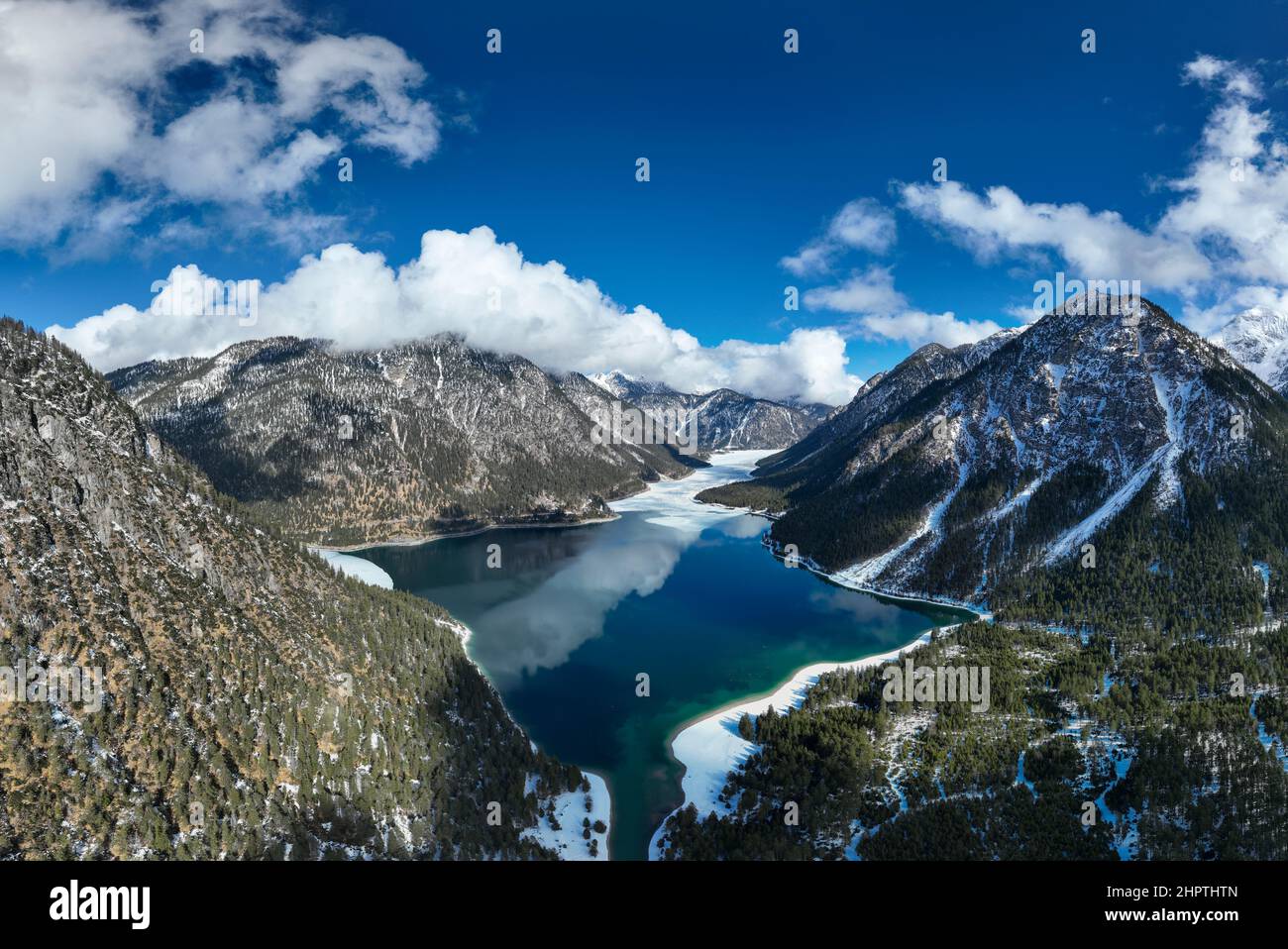 cold blue lake plansee on sunny day in tyrol alps mountains in winter Stock Photo