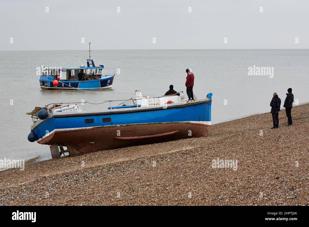 Herne Bay, Kent, UK. 23rd February 2022. UK Weather. A fishing boat beached at Herne Bay in Kent is attempted to be refloated. The boat is believed to have broken it's moorings in Essex and been blown over by strong winds from Storm Franklin on Monday. The attempt to refloat failed. Credit: Alan Payton/Alamy Live News. Stock Photo