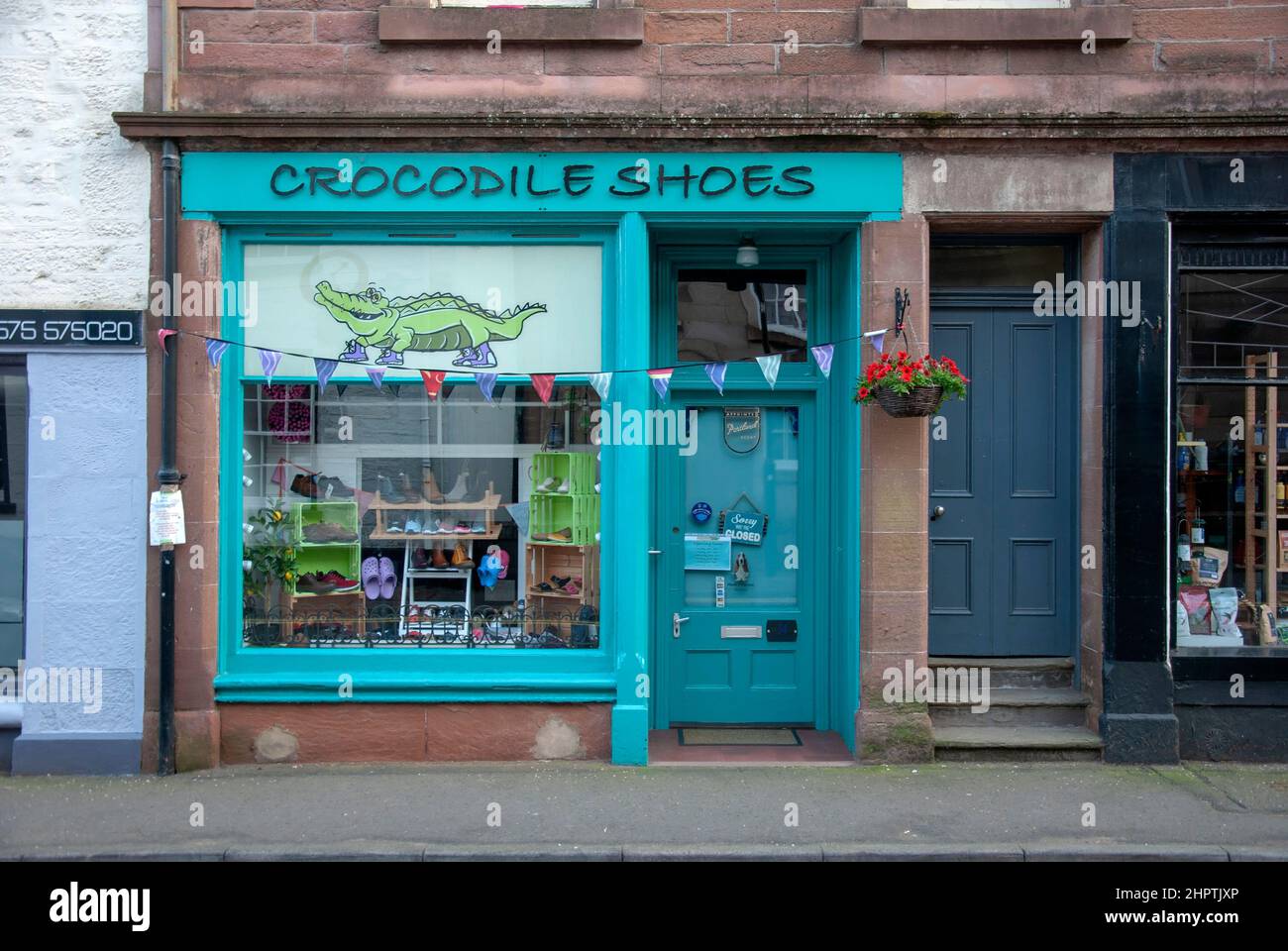 Crocodile Shoes Shoe Shop Bank Street Kirriemuir Angus Scotland United Kingdom exterior view red sandstone turquoise teal blue painted commercial reta Stock Photo