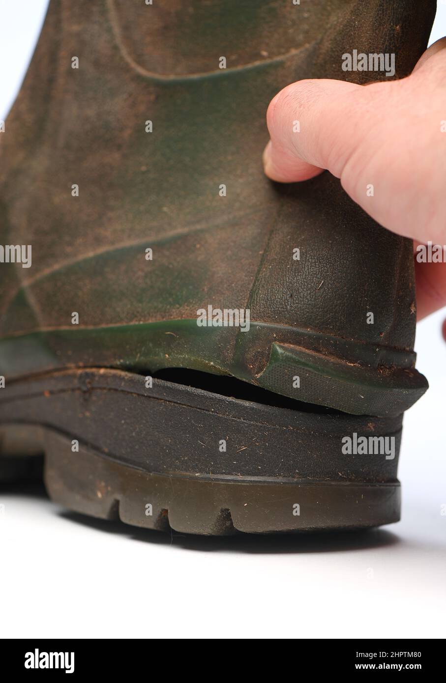 A wellington boot with a hole or split in it where the top has come away from the sole. Stock Photo