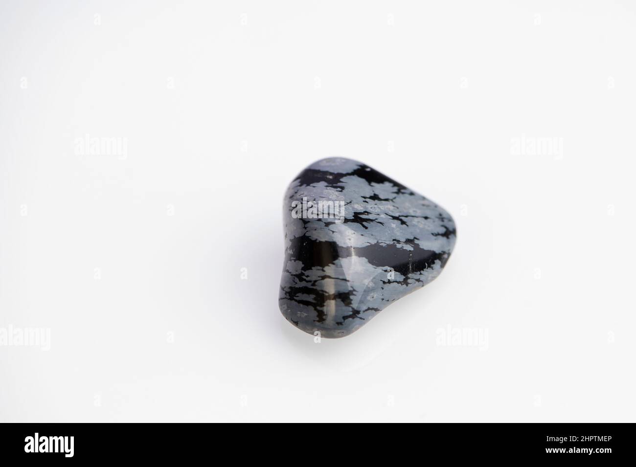 snowflake obsidian gemstone on white background Stock Photo