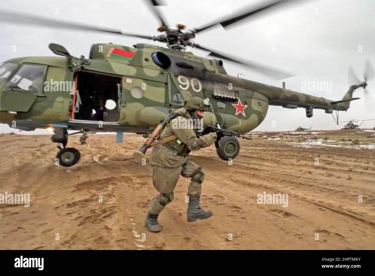 RUSSIAN soldier with Mi-8AMT helicopter on the Ukrainian border in February 2022 before the invasion. Stock Photo