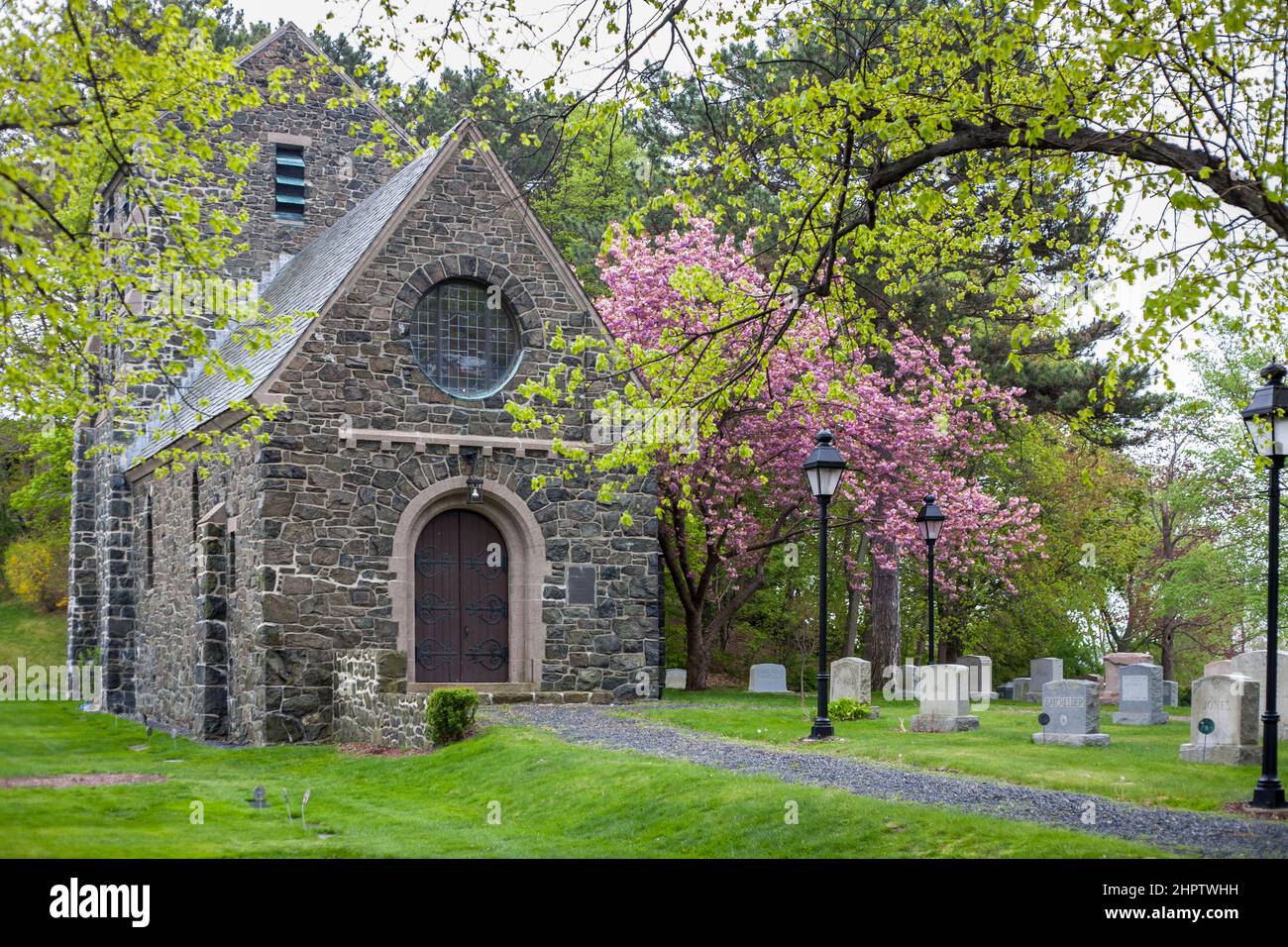 Chapel at the Greenlawn Cemetery Nahant: A quaint stone chapel surrouned by spring flowers and new leaves in the nationally listed cemetery on this small New England island. Stock Photo