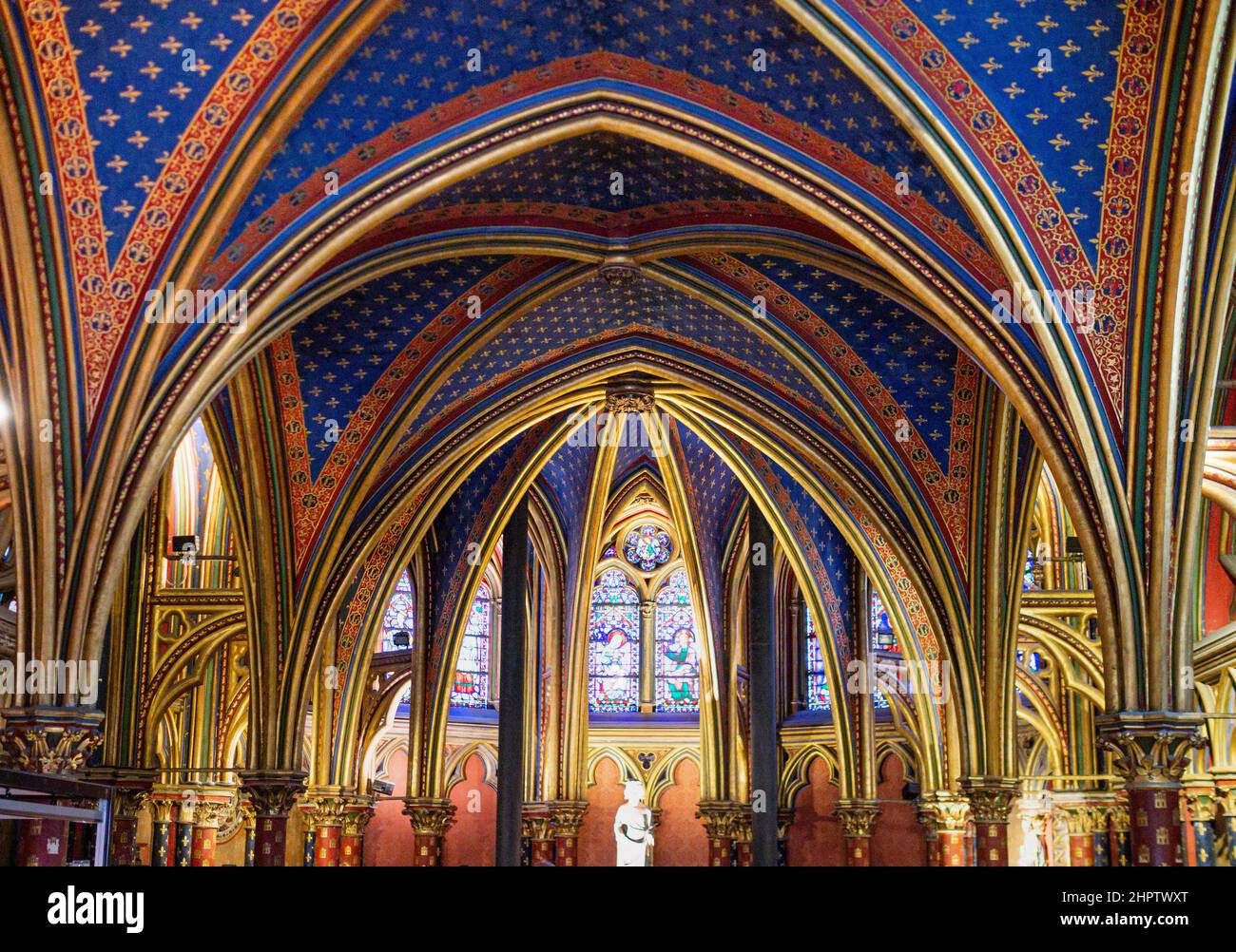 Ceiling of the Lower Floor Sainte Chapelle: Extravagant arches gilded with gold in a deep blue ceiling dominate the lower level of the famous chapel. Stock Photo