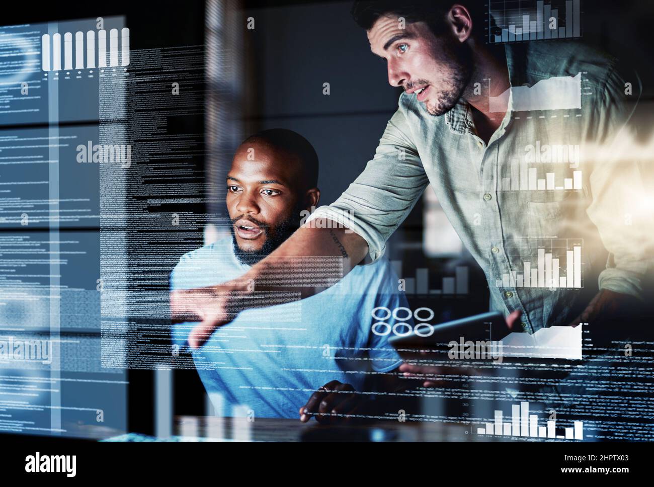 Lets test this algorithm. Shot of two programmers working together on a computer code at night. Stock Photo