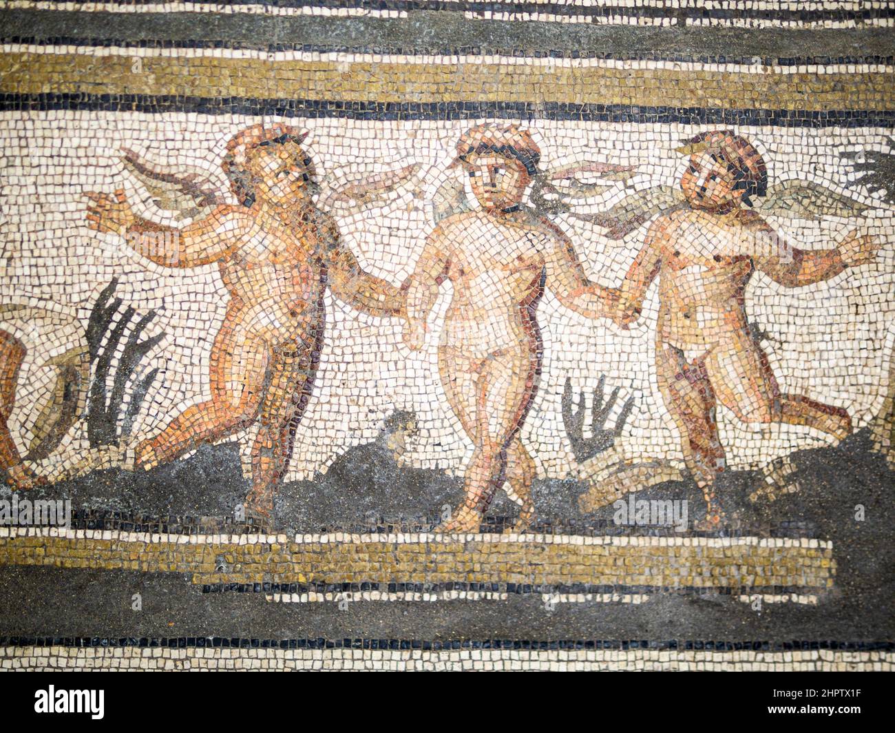 Detail from a Greek Mosaic of 3 winged nymphs holding hands in a garden: Fromm the mosaic of the Seasons found in Daphine near Antioch-sur-Orontes, Antakya, Turkey.  c. 325 AD.   Made from cubes of limestone. Stock Photo