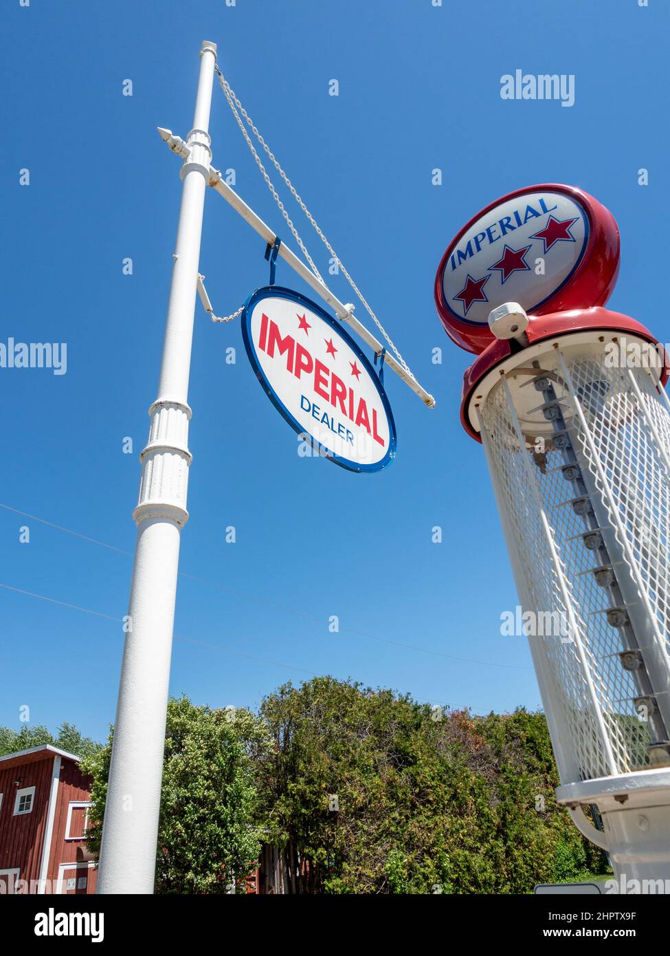 Vintage Imperial Gas Pump: An Imperial sign with an old gas pump behind against a bright blue sky. Stock Photo