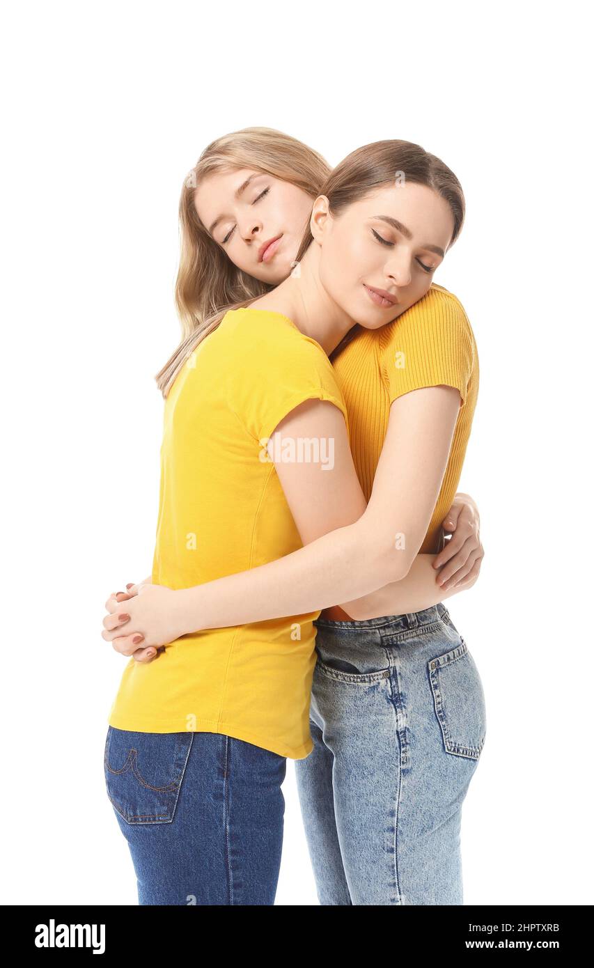 Portrait of hugging young sisters on white background Stock Photo