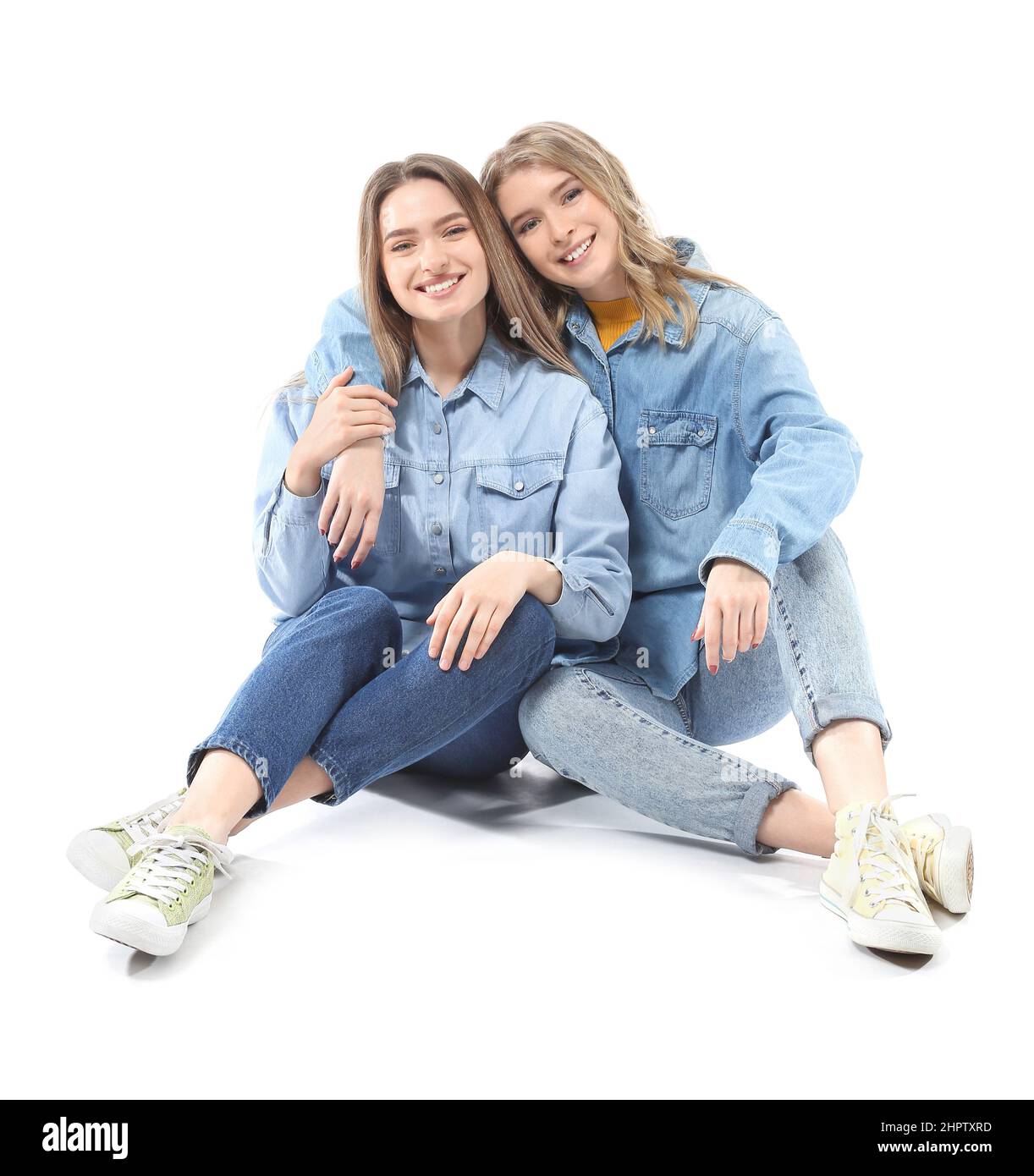 Portrait of young sisters isolated on white Stock Photo