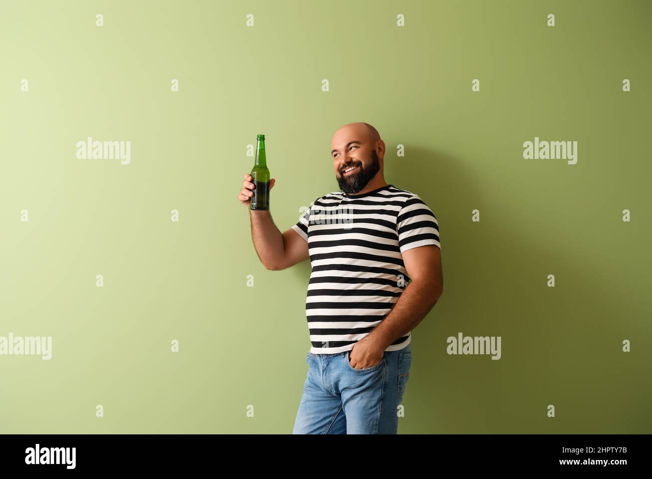 Bald man with beer on color background Stock Photo
