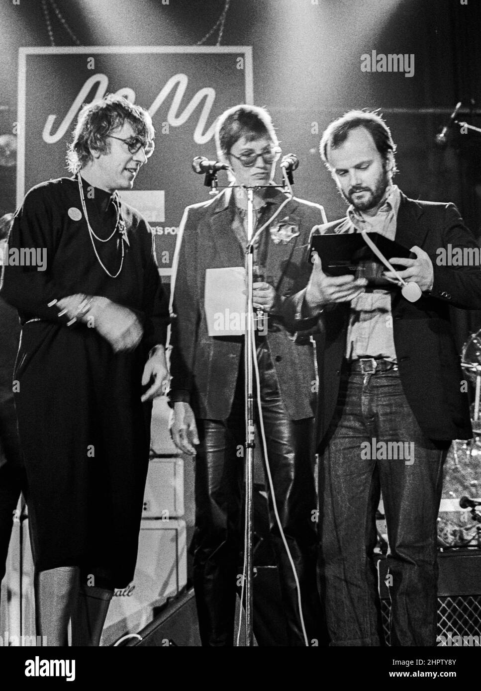 British DJ John Peel, OBE receiving an award from Peter Cook (wearing a dress) and Janet Street-Porter at a Melody Maker poll awards ceremony in London in 1979. Real name John Ravenscroft. Stock Photo
