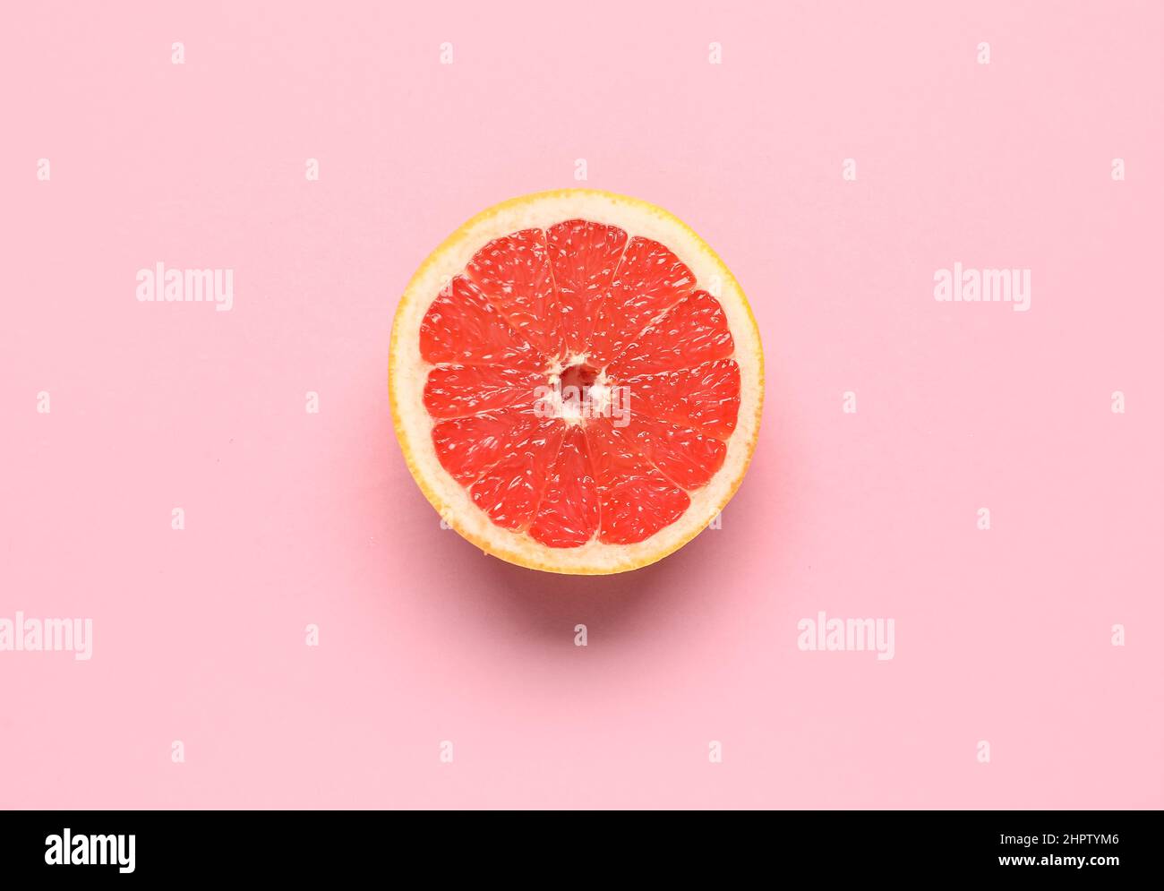 Tasty half grapefruit on pink background Stock Photo Alamy