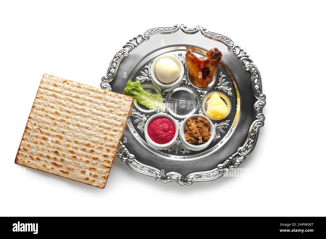 Passover Seder plate with traditional food and matza on white ...