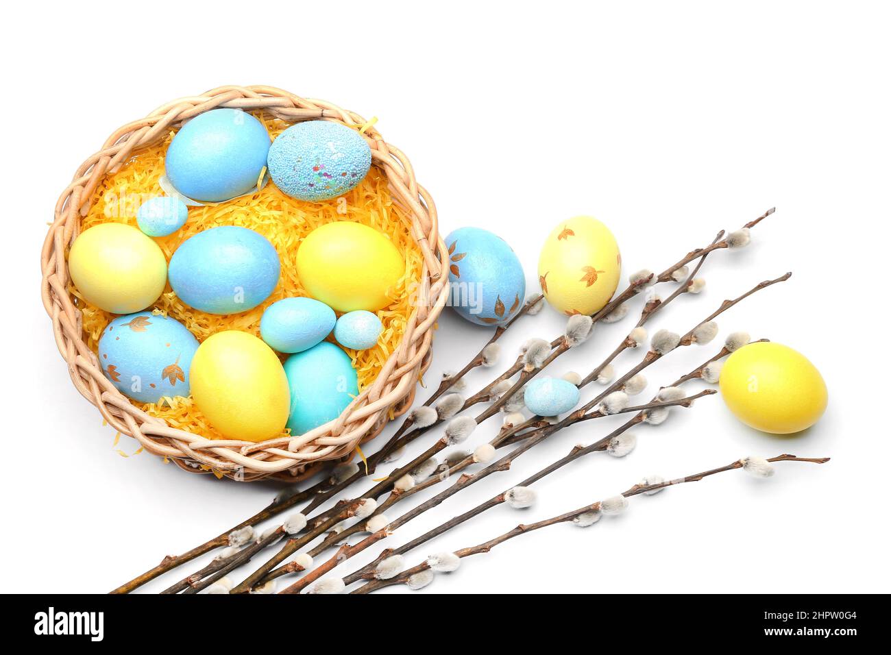 Nest with painted Easter eggs and pussy willow branches on white ...