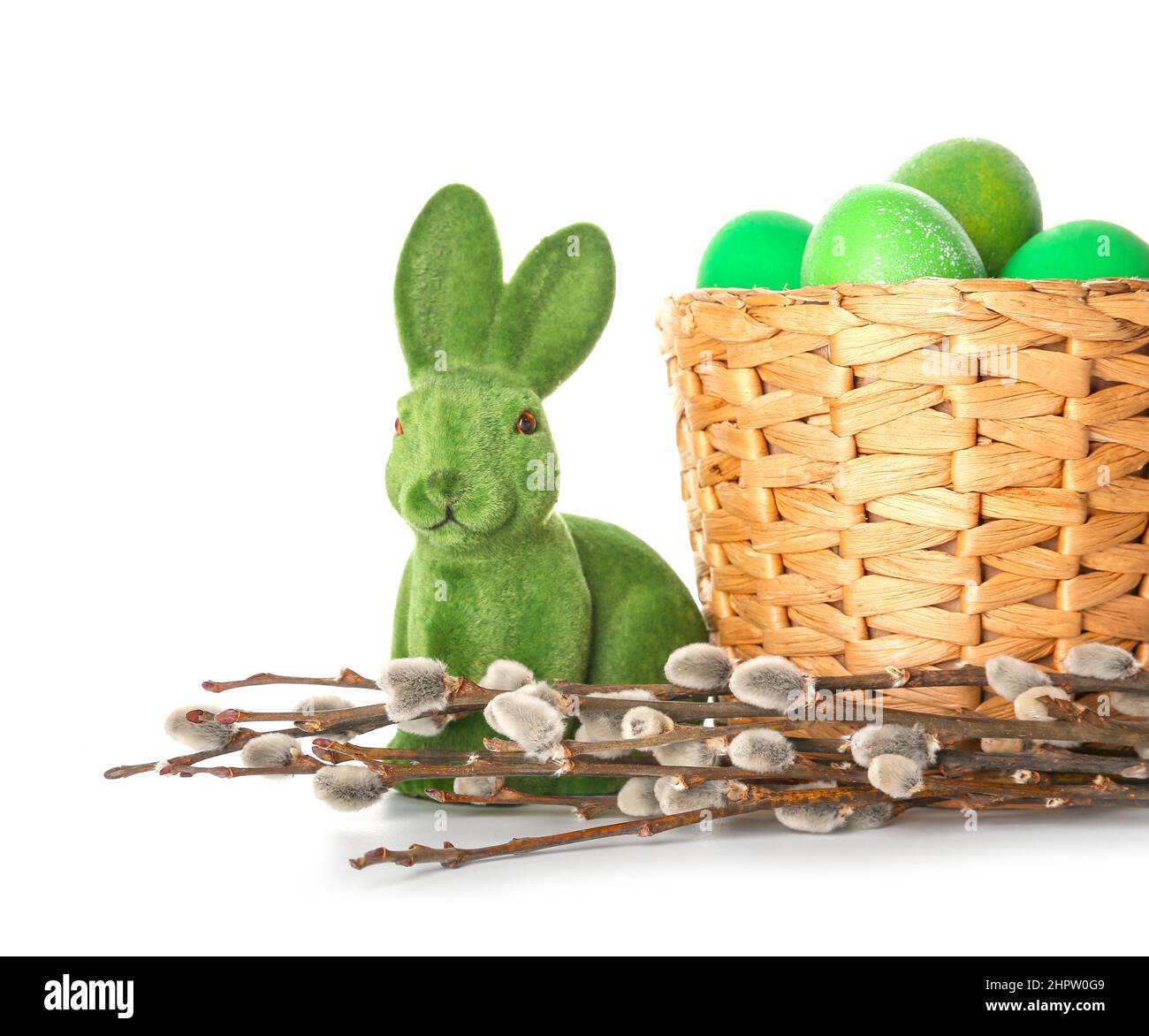 Basket with painted Easter eggs, rabbit and pussy willow branches on ...