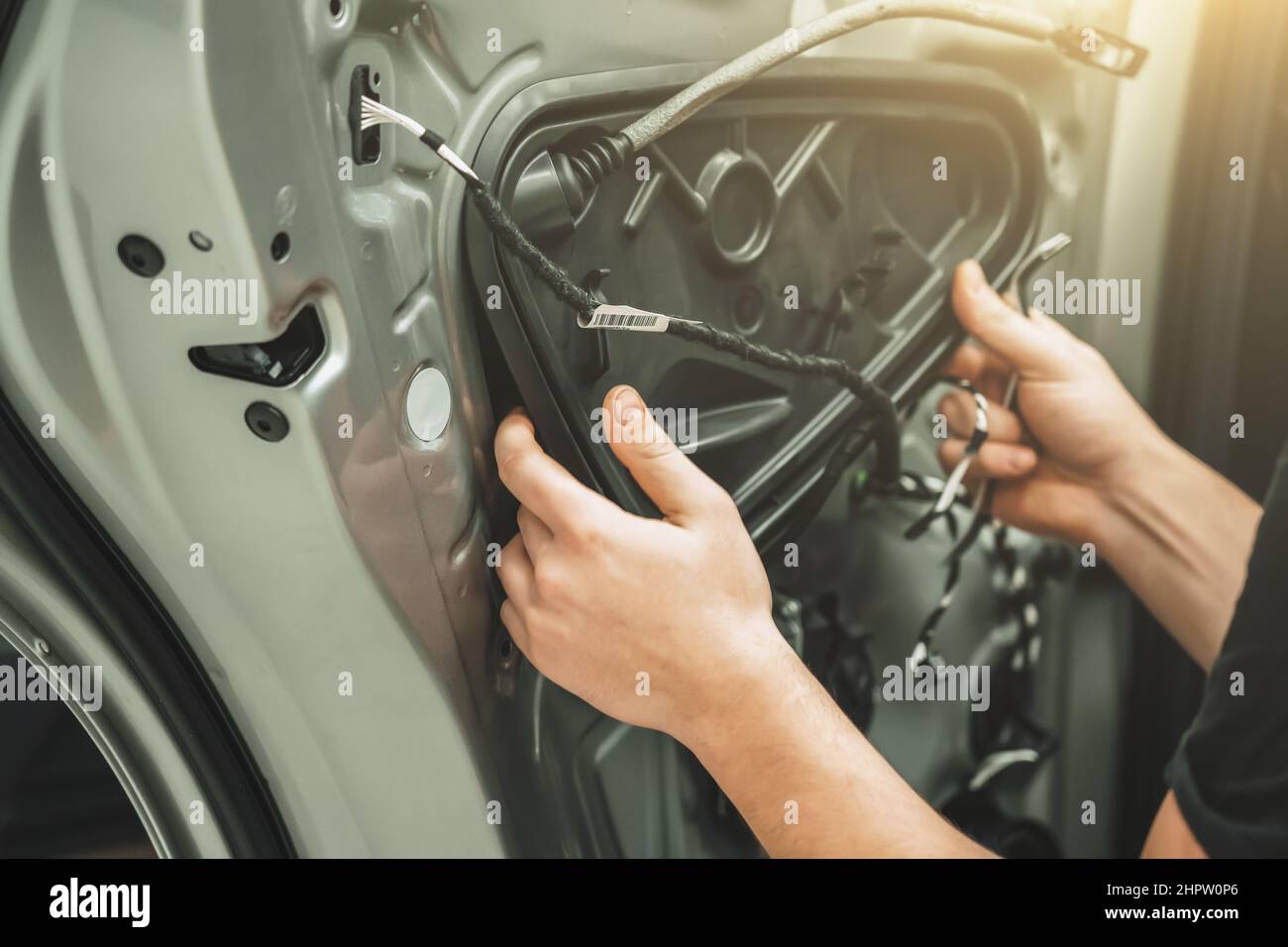 Auto service worker disassembles car door for repair close up. Stock Photo
