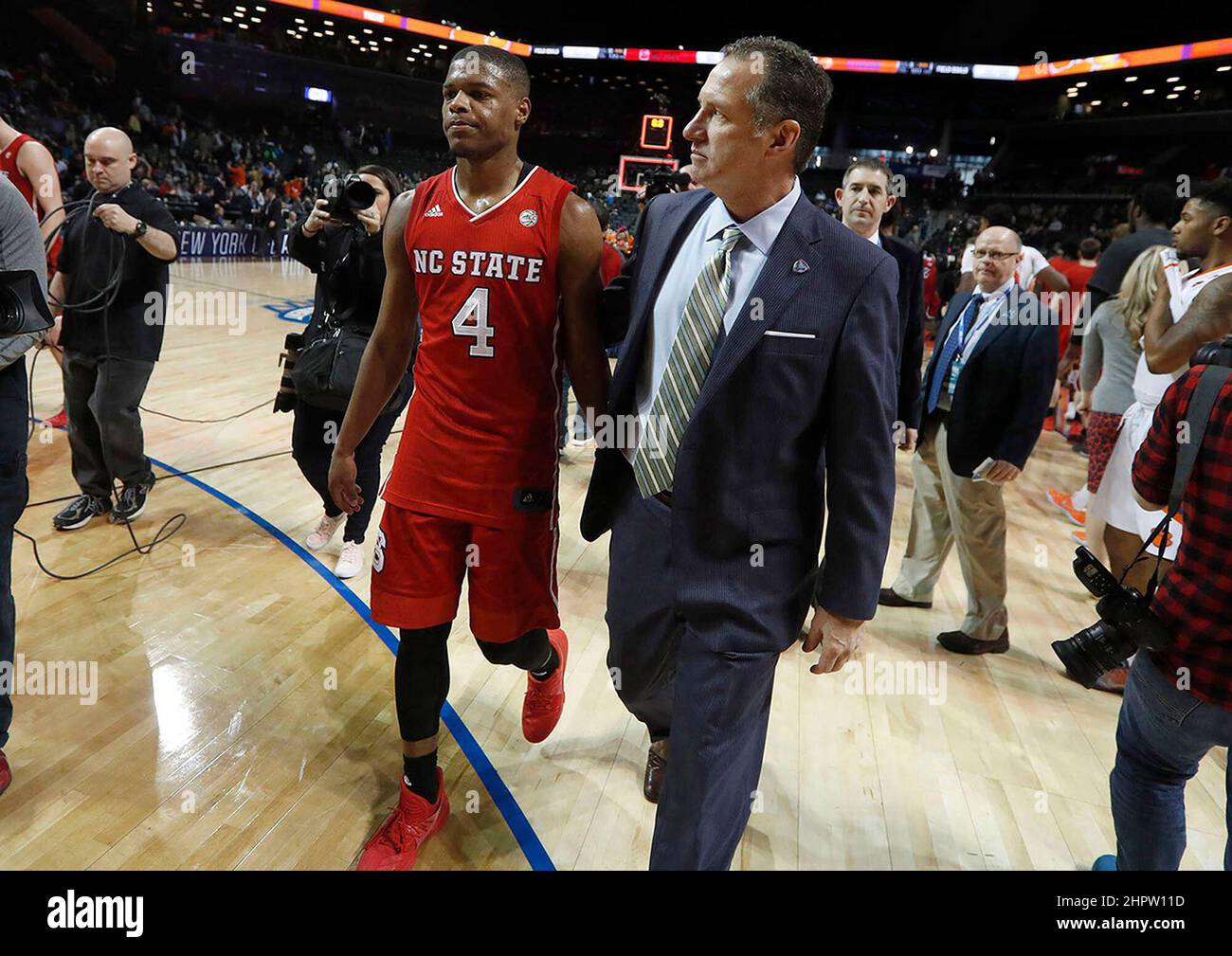 New York, USA. 07th Mar, 2017. In this file photo, North Carolina State head coach Mark Gottfried walks off the floor with Dennis Smith Jr. (Photo by 4) after a 75-61 loss against Clemson in the first round of the ACC Tournament at the Barclays Center in Brooklyn, N.Y., on March 7, 2017. (Photo by Ethan Hyman/Raleigh News & Observer/TNS/Sipa USA) Credit: Sipa USA/Alamy Live News Stock Photo
