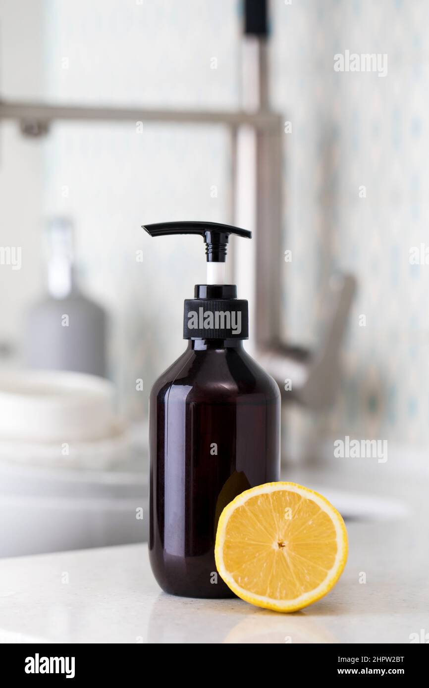 Bottle with eco friendly dishwashing detergent with lemon on the