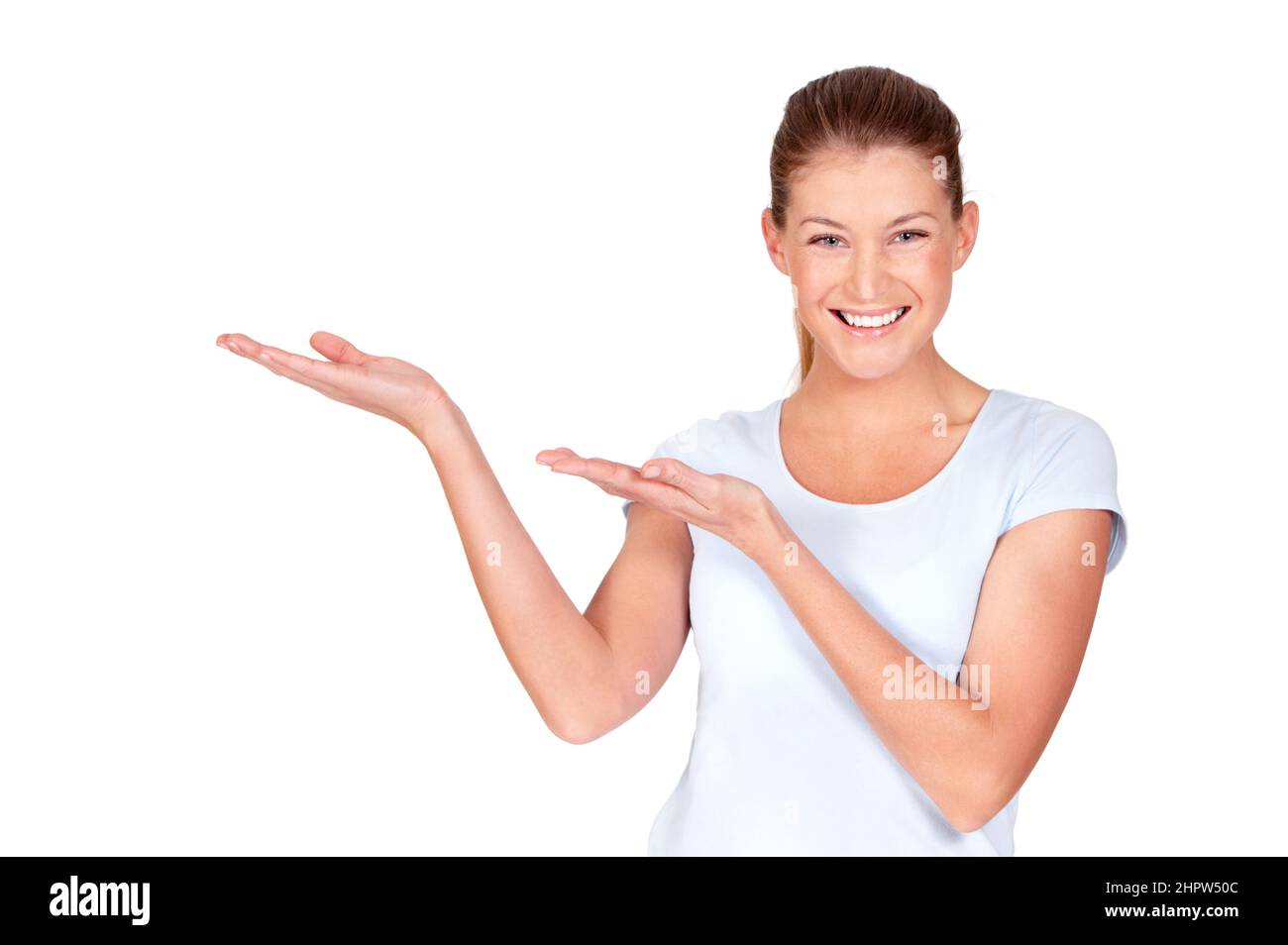 I fully endorse this as awesome. A pretty young woman presenting something to you while isolated on white. Stock Photo