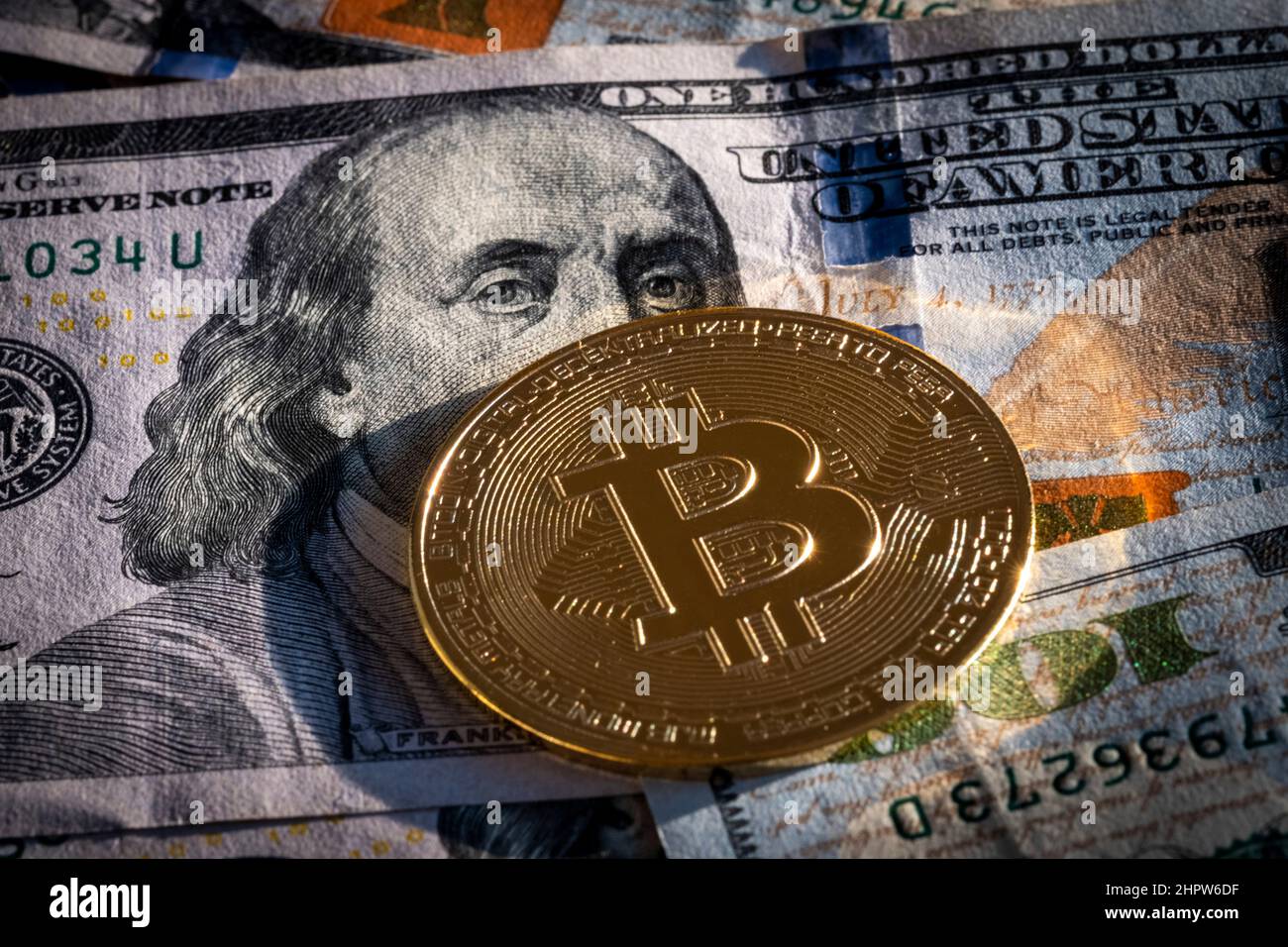 Cryptocurrency bitcoin on a one hundred dollar bill Stock Photo - Alamy