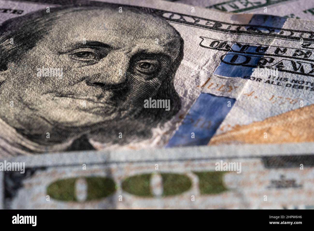 Closeup on Benjamin Franklin portrait on a one hundred US American paper banknote currency. Money for exchange. Global recession and inflation rate Stock Photo