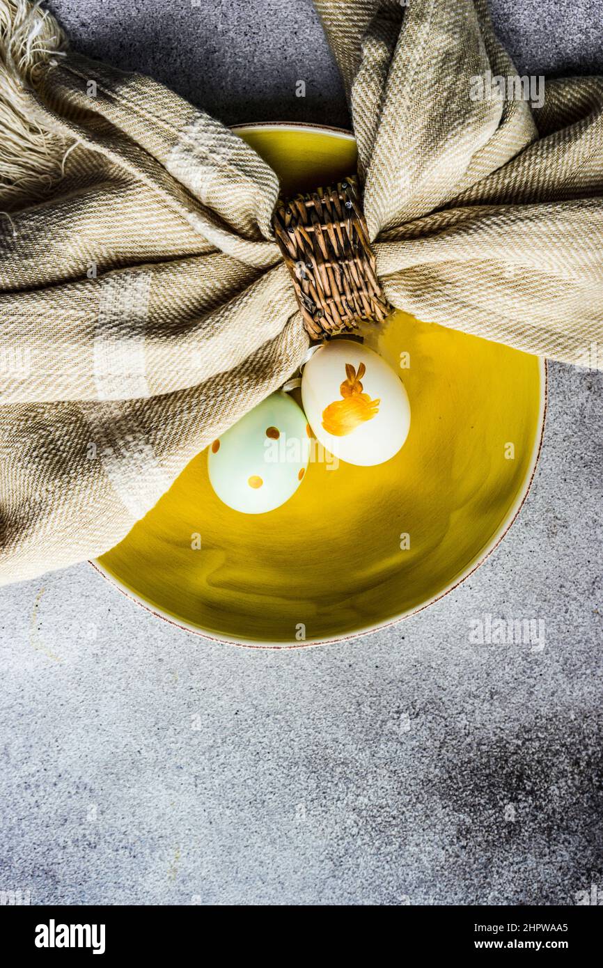 Easter minimalistic place setting on concrete background Stock Photo