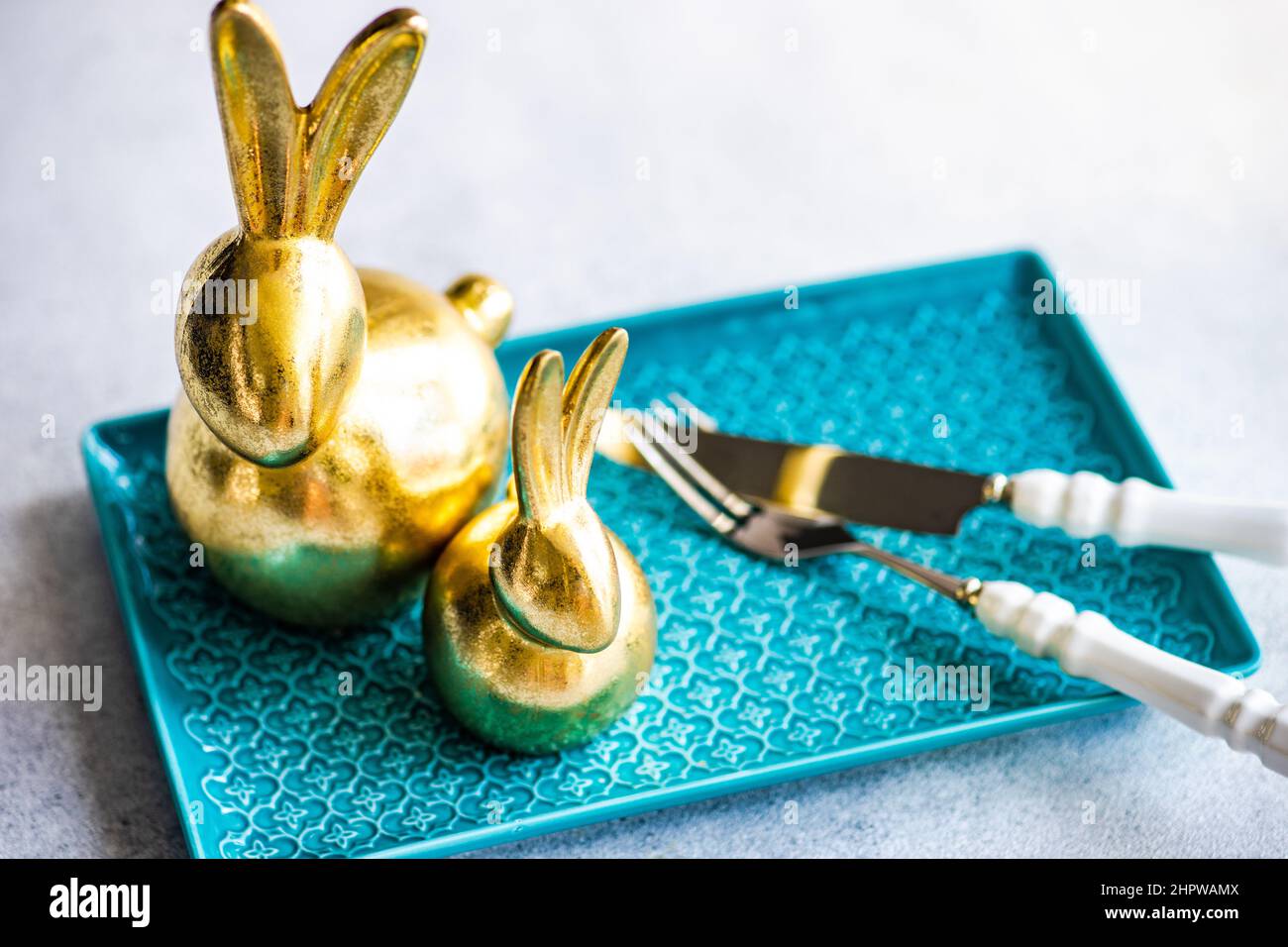 Place setting for festive Easter dinner using with golden bunnies Stock Photo