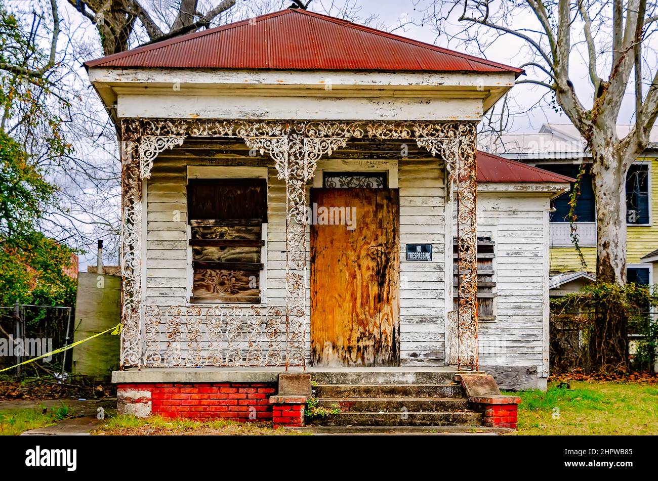 A historic shotgun house is boarded up and dilapidated in the Central Business District, Feb. 21, 2022, in Mobile, Alabama. Stock Photo