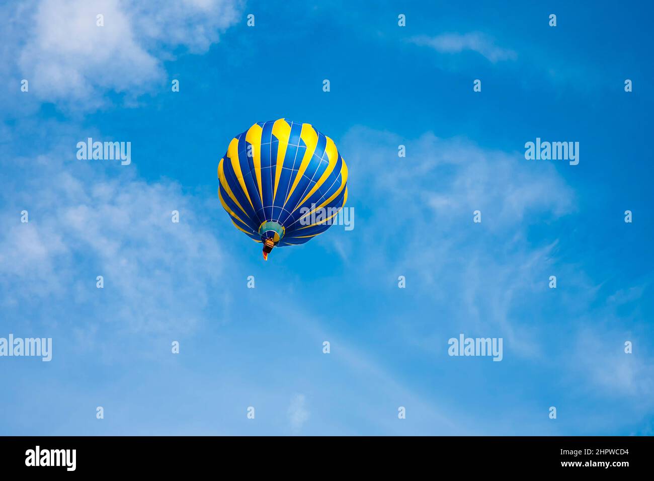 moving Hot Air Balloon under blue sky Stock Photo - Alamy