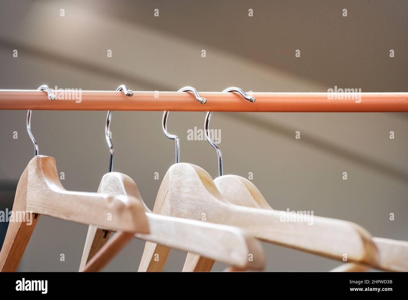 Wooden hangers hung on a light brown or tile bar Stock Photo