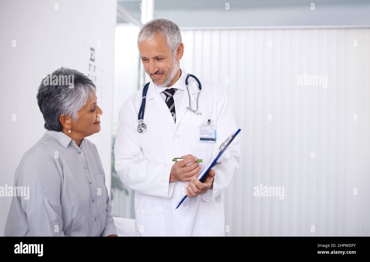The results are very positive. A happy doctor seeing to one of his mature patients. Stock Photo