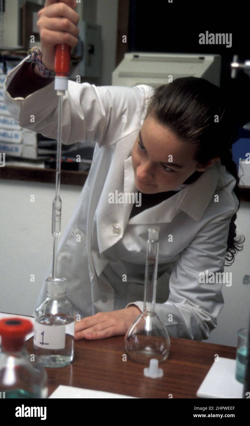 senior school student undergoing science experiment in classroom Stock Photo