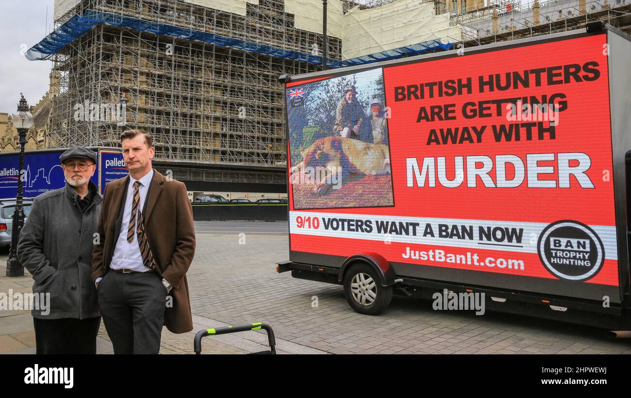 London, UK. 23rd Feb, 2022. Dave Doogan, MP, lends his support to activists with the Campaign to Ban Trophy Hunting who have placed a mobile display outside Parliament to inform about the cruelty of trophy hunting. Credit: Imageplotter/Alamy Live News Stock Photo