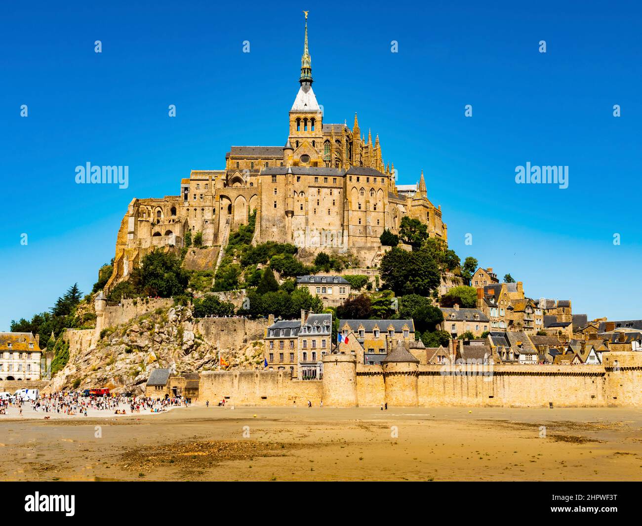 Le Mont Saint Michel, stunning view of the famous abbey during low tide on a bright sunny day, Normandy, Northern France Stock Photo
