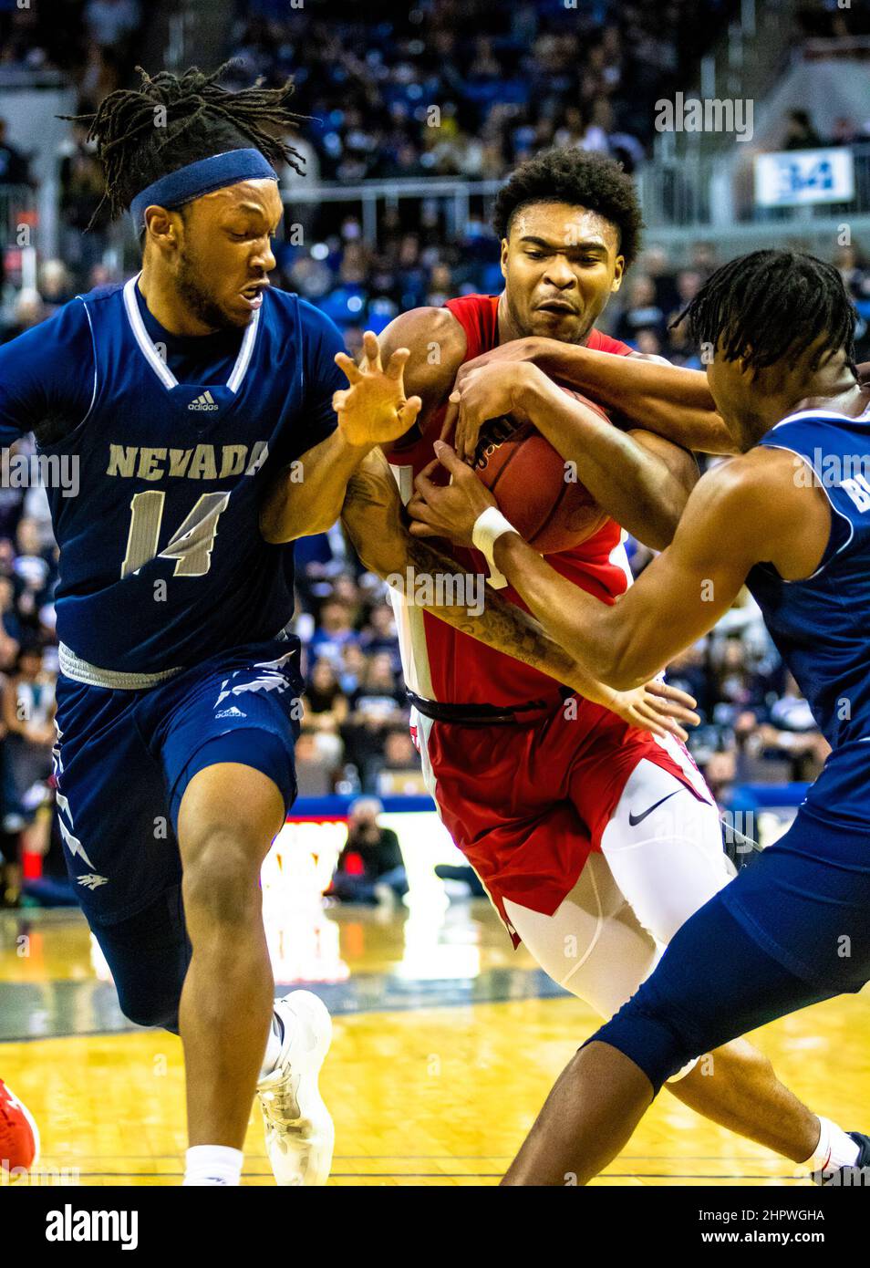 Reno, United States. 22nd Feb, 2022. Las Vegas player guard #13 Bryce Hamilton tries to push through Reno's guard #1 Kenan Blackshear and forward #14 TrÈ Coleman during the University of Las Vegas vs University of Nevada Reno match at Lawlor event centre and University of Las Vegas came out victorious, 62 to 54. (Photo by Ty O'Neil/SOPA Images/Sipa USA) Credit: Sipa USA/Alamy Live News Stock Photo