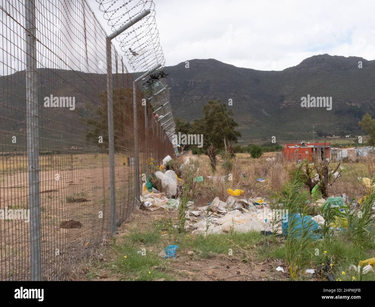 Plastic litter against a wire fence in a rural area Stock Photo - Alamy