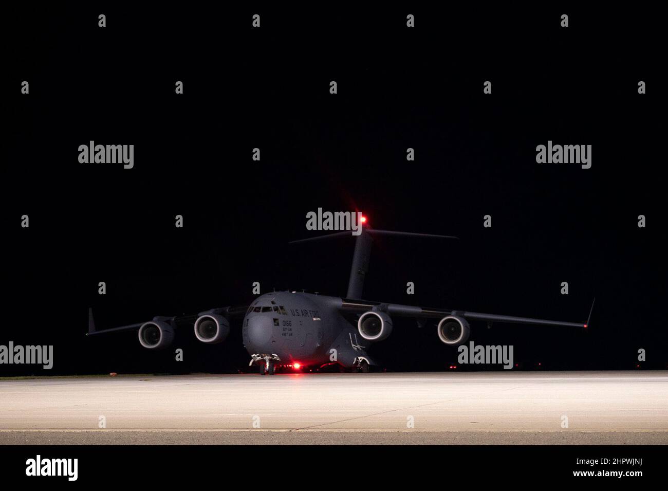 A C-17 Globemaster III assigned to Joint Base Lewis-McChord, Washington, arrives at Travis Air Force Base, California, Feb. 14, 2022. U.S. Airmen with the 60th Aerial Port Squadron and 8th Airlift Squadron load K-loaders onto the C-17. K-loaders are used to transport cargo into and out of aircraft. Under the direction of U.S. Transportation Command, the 60th Air Mobility Wing supported the 621st Contingency Response Wing during the movement of security assistance cargo to Ukraine via commercial cargo aircraft. The Defense Security Cooperation Agency coordinated the effort. (U.S. Air Force phot Stock Photo