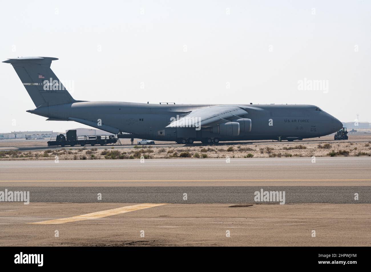 A U.S. Air Force C-5M Super Galaxy from the 60th Air Mobility Wing, Travis Air Force Base, takes on cargo at Al Dhafra Air Base, United Arab Emirates, Feb. 16, 2022. The C-5 is a strategic transport aircraft used to transport cargo and personnel for the Department of Defense. (U.S. Air Force photo by Staff Sgt. Nicholas Ross) Stock Photo