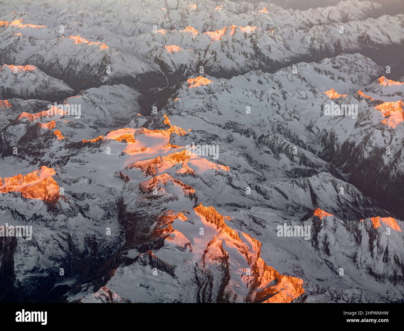 aerial of sunrise in the italian Alps with snow covered mountains Stock ...