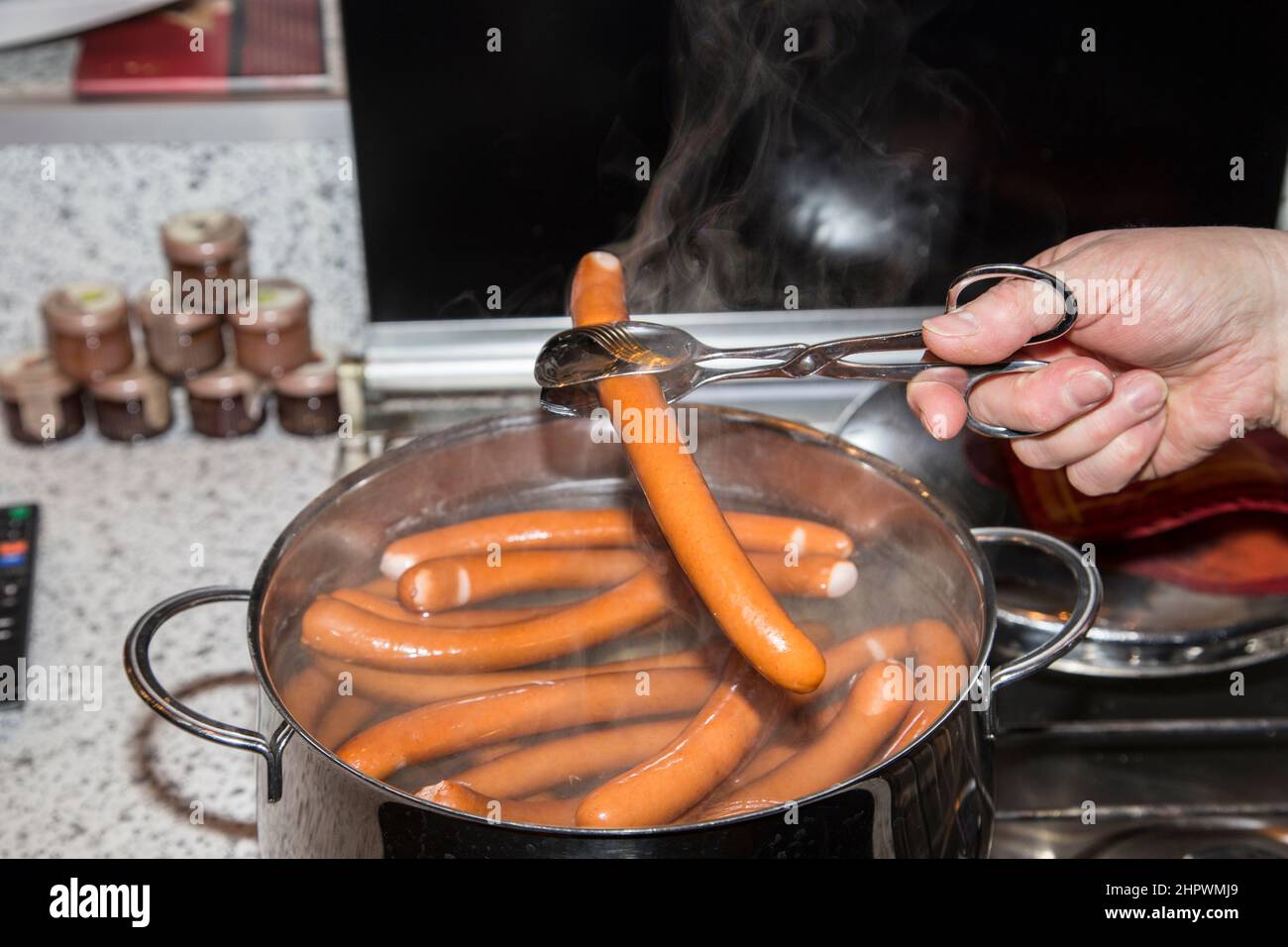 sausages are boiling in a pot of water Stock Photo Alamy