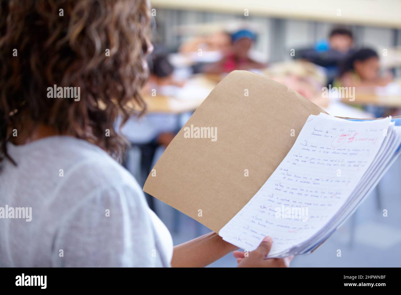 Ready to announce the marks. An over the shoulder view of a teacher ...